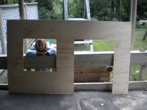 a large piece of plywood with two squares cut out