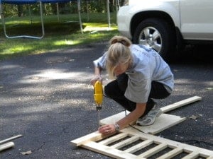 a woman making a wood railing