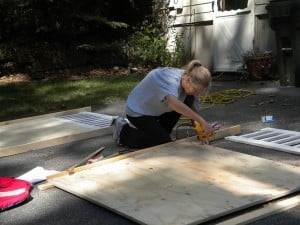 A woman drilling pieces of wood together