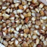 a baking dish full of diced roasted potatoes