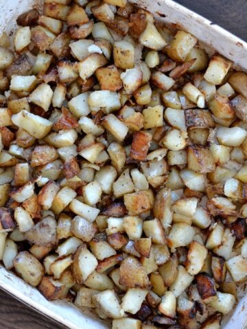 a baking dish full of diced roasted potatoes