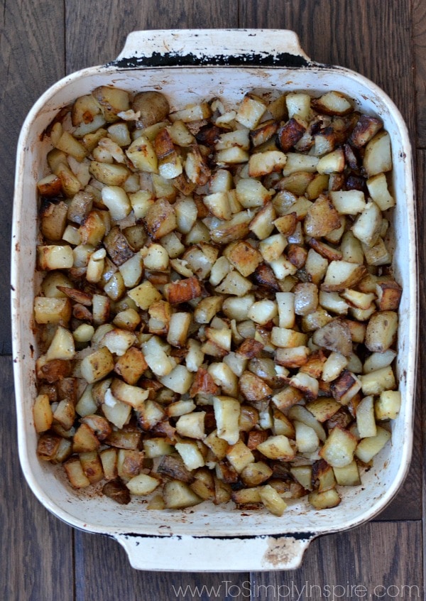 a baking dish full of diced roasted potatoes