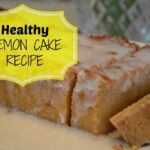 glazed lemon cake loaf with two slices cut on a white plate