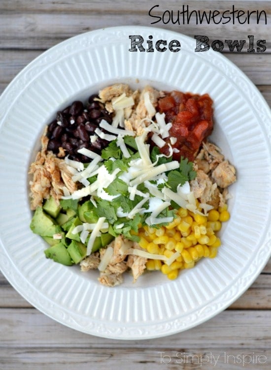 a white bowl with corn, avocado, black beans, salsa, chicken  and cheese