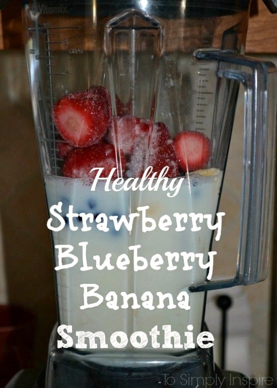 fresh strawberries, blueberries and milk in a blender