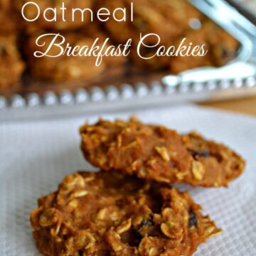 pumpkin oatmeal cookies on a white napkin with a plateful in the background