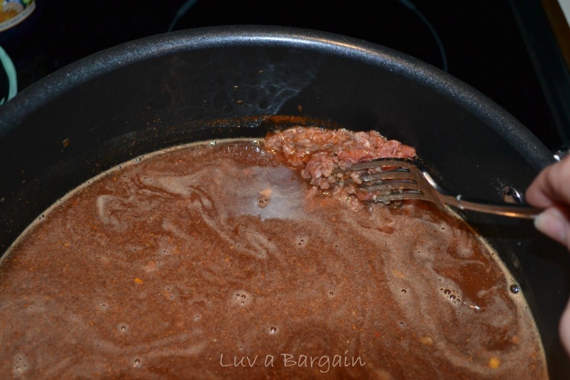 a black pot with hamburger in tomato sauce