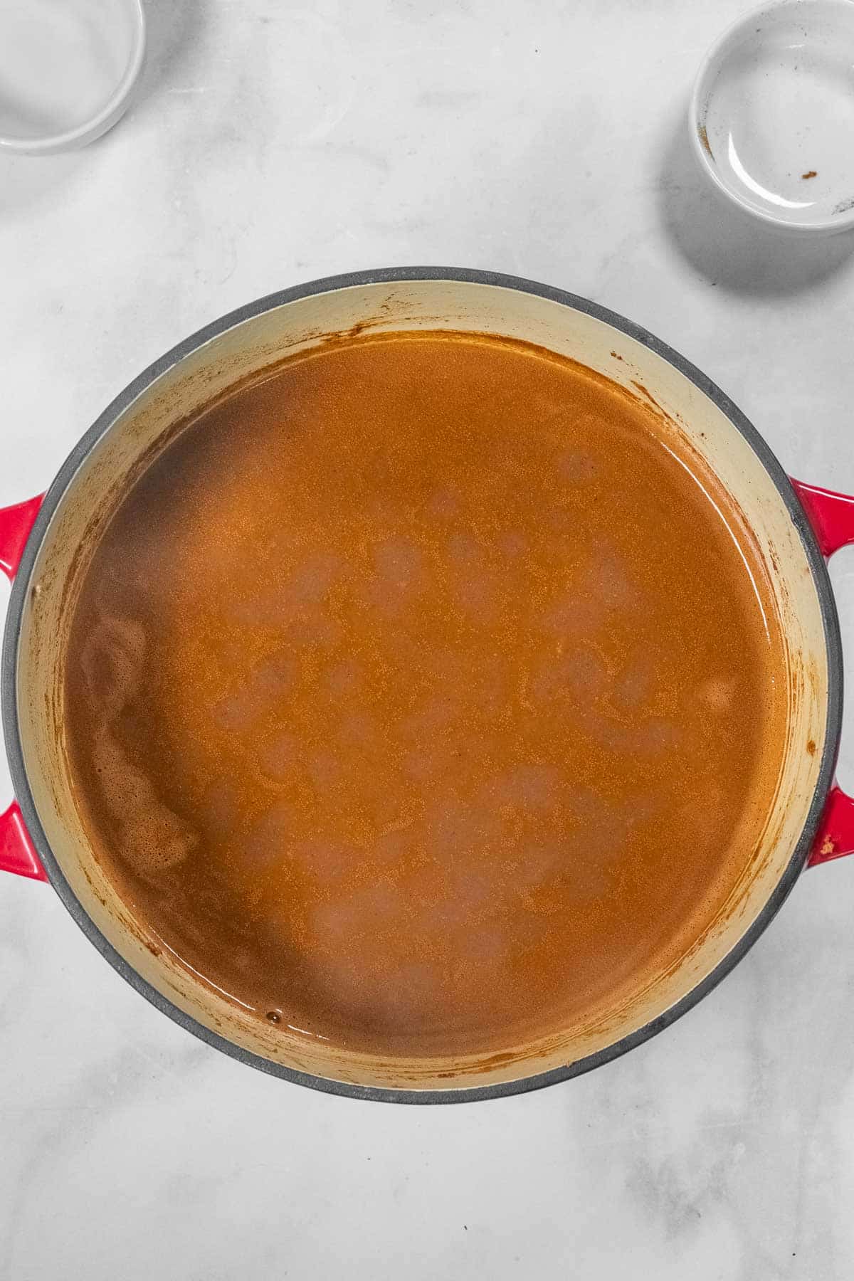 a black pot with hamburger in tomato sauce