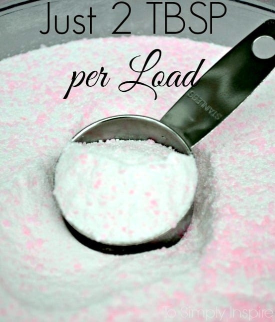 a closeup of homemade powdered laundry detergent bing scooped with a metal scooper