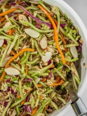 Balsamic Broccoli Slaw recipe served in a green bowl with tex overlay "Balsamic Broccoli Slaw".