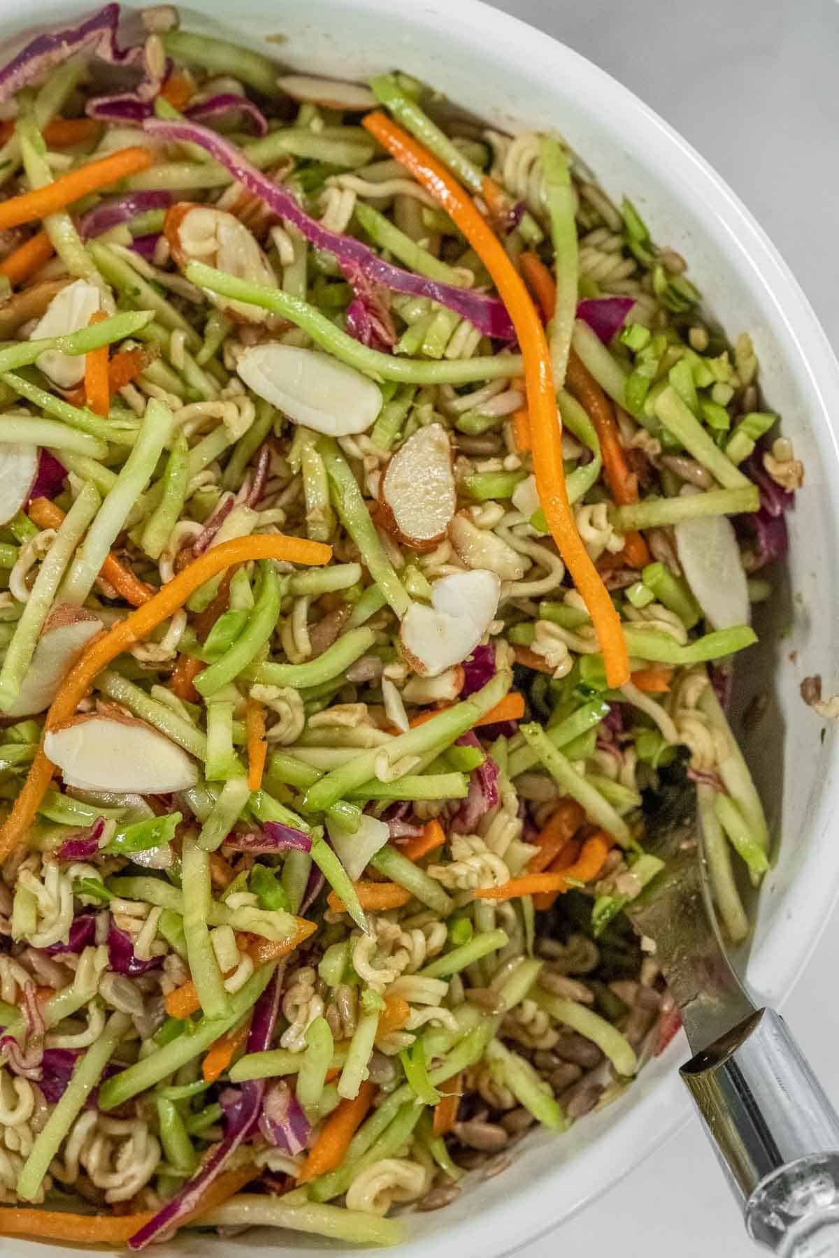 Balsamic Broccoli Slaw recipe served in a green bowl with tex overlay \"Balsamic Broccoli Slaw\".