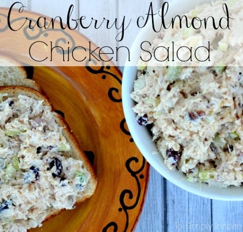 a plate with a chicken salad sandwich next to a bowl full of chicken salad