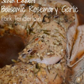 A close up of pork tenderloin in brown sauce with garlic