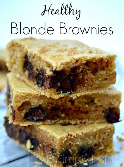 three blonde brownies with chocolate chips stack on a plate