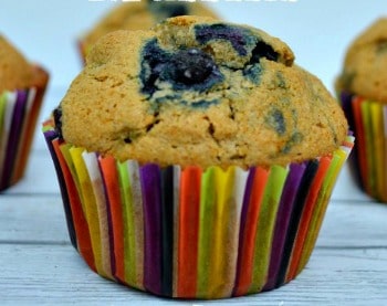 closeup of a blueberry muffin in rainbow liner paper