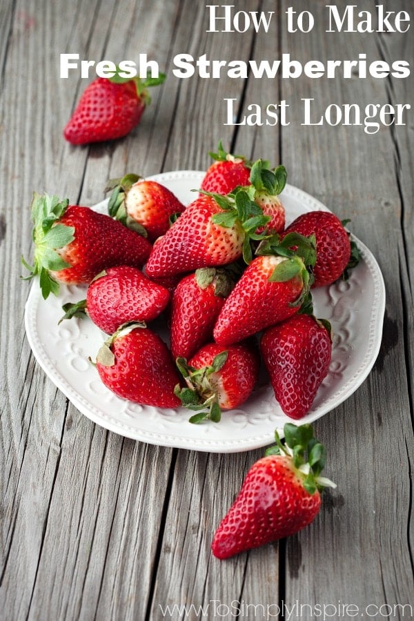 Learn how to make fresh strawberries last longer with this amazing simple tip. a bunch of fresh strawberries on a white plate