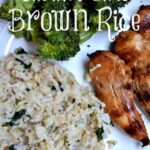 brown rice, broccoli and grilled chicken tenders on a white plate
