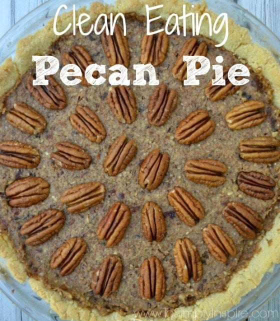 pecan pie topped with pecan halves in a pattern on a grey table 