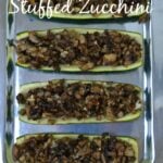 hollowed out zucchini halves filled with sautéed mushrooms on a silver plate
