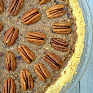 closeup of pecan pie with pecans halves all over the top