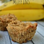 banana coconut muffins on a grey wood table with bananas