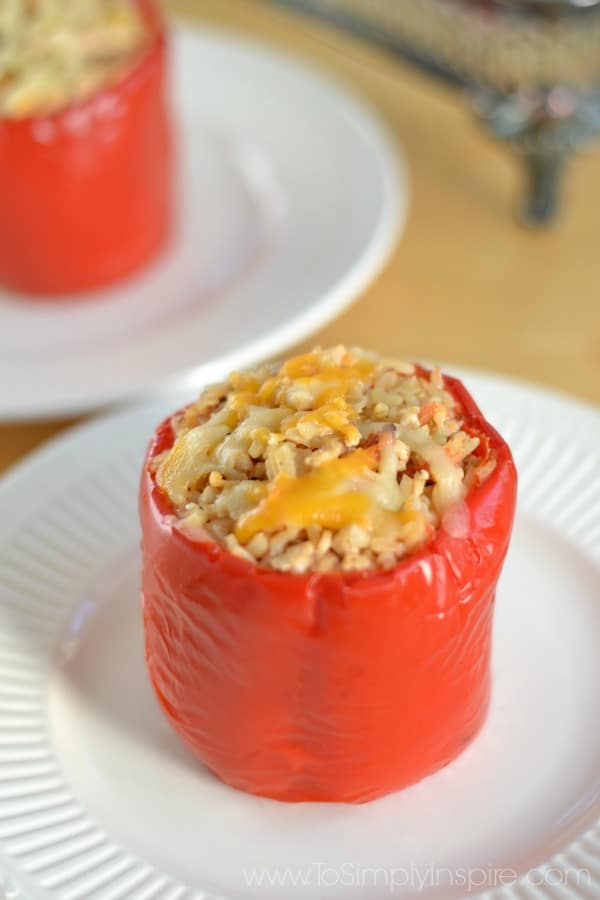 a closeup of a red pepper stuffed with a mixture of brown rice, ground turkey and spices