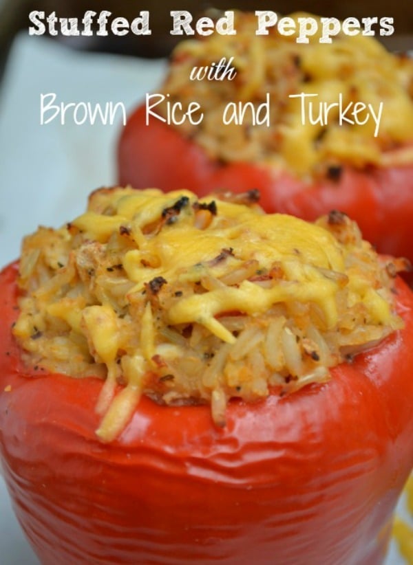 closeup of red peppers stuffed with a mixture of brown rice, ground turkey and spices