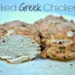 chicken breasts cooked in greek seasonings on a white plate.