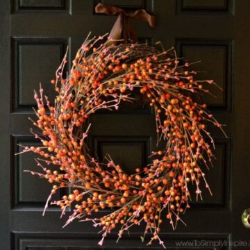 Orange and Red Berry Fall Wreath on a Black Door