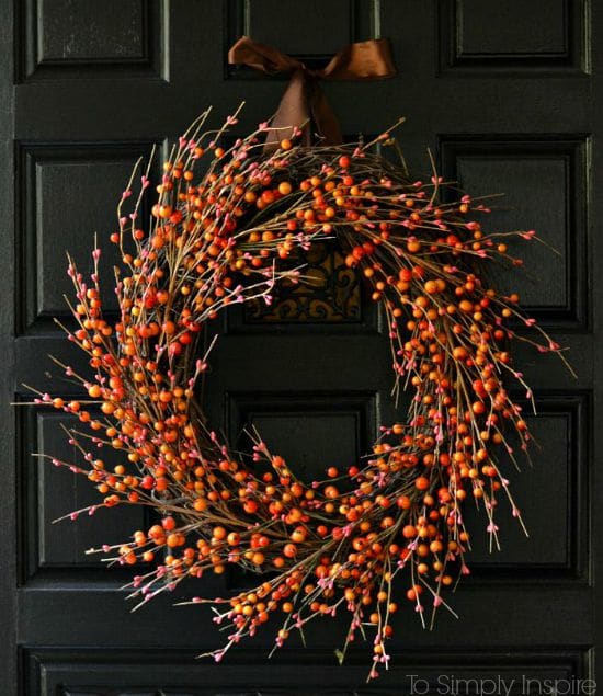 Orange and Red Berry DIY Fall Wreath on a black door