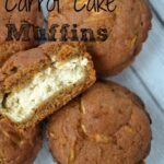 carrot cake muffins with one cut in half and filled with cream cheese frosting