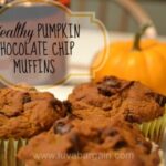 three pumpkin chocolate chip muffins on with a min pumpkin