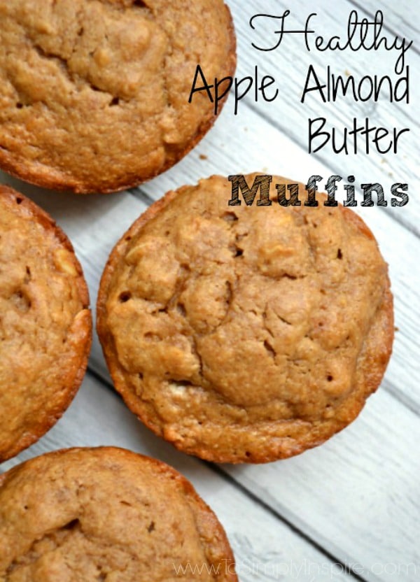 four almond butter muffins on a grey wood table