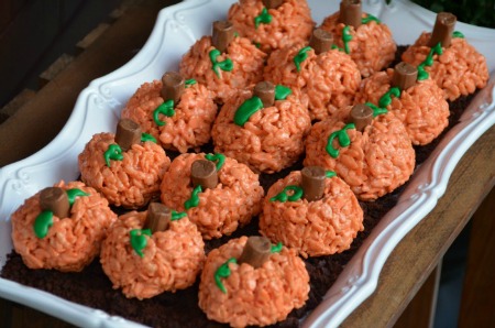 A close up of pumpkin shaped rice krispie treats 