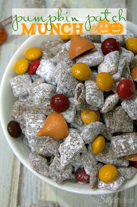 A plate is filled sugar coated chex mix with red and yellow candies