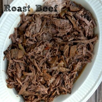 shredded roast beef in a white oval bowl