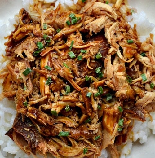 overhead picture of Shredded chicken teriyaki over white rice with scallions on top