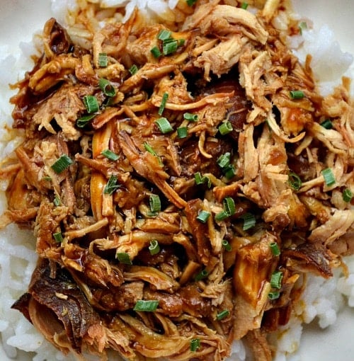 Slow Cooker Chicken Teriyaki overhead picture of Shredded chicken teriyaki over white rice with scallions on top