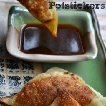 chicken potsticker being dipped into soy sauce