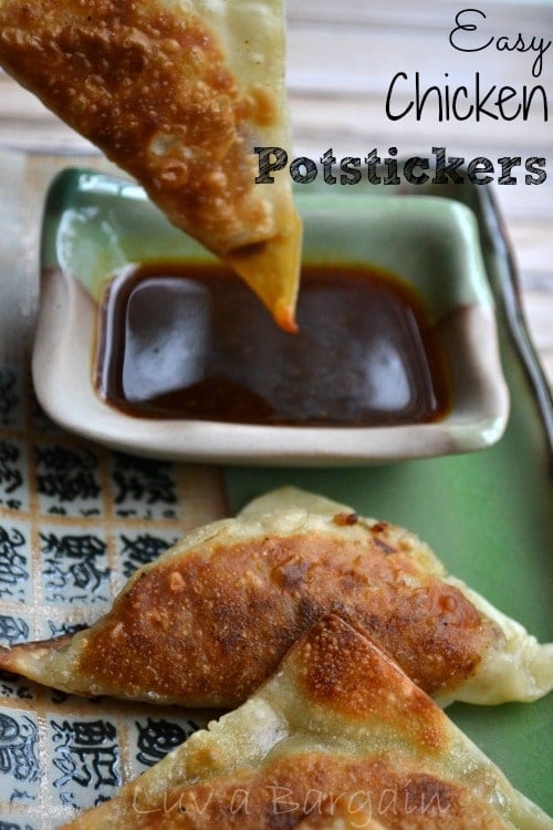 chicken potsticker being dipped into soy sauce