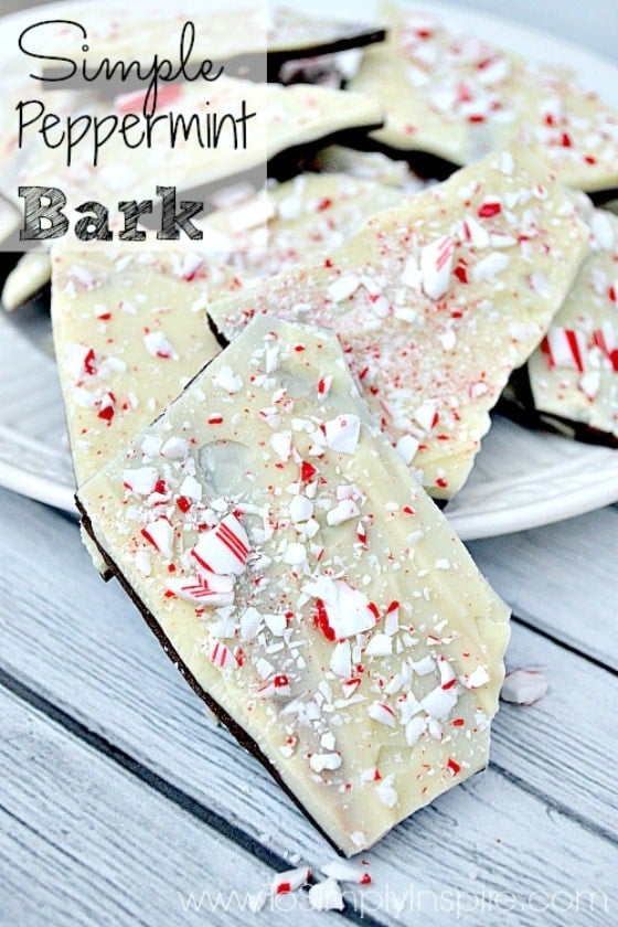 This simple Peppermint Bark Recipe is made from 3 simple ingredients - dark chocolate topped with white chocolate then sprinkled with crushed candy canes. A perfect Holiday treat! Peppermint Bark pieces on a white plate