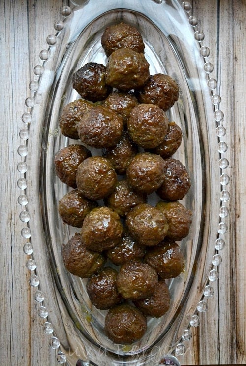 a glass plate with saucy cocktail meatballs
