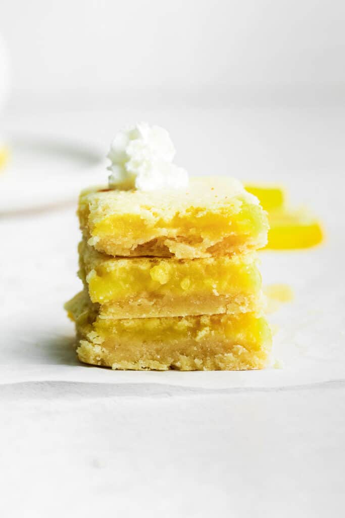 stack of three lemon bars on a white table