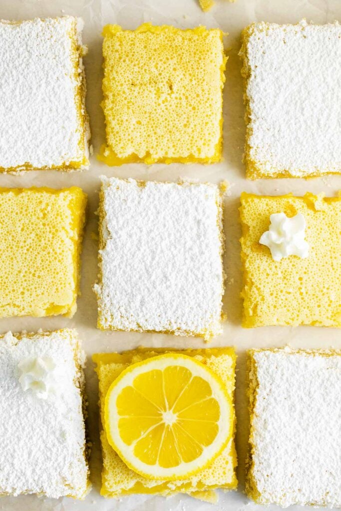 closeup of nine lemon bars some covered with powdered sugar