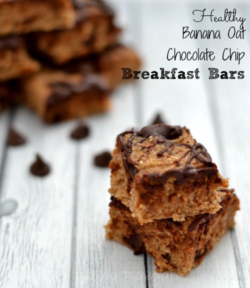 a stack of two banana bars drizzled with chocolate on a gray wood table