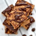 A close up of banana bars drizzled with chocolate