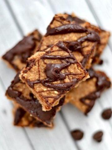A close up of banana bars drizzled with chocolate