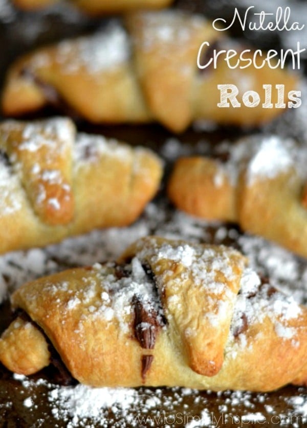 A close up of crescent roll with Nutella and powdered sugar