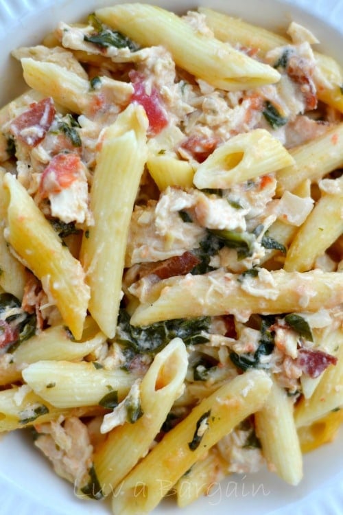 A close up of pasta, bacon and chicken