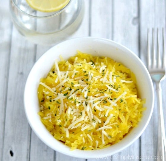 Parmesan Garlic Spaghetti Squash in a white bowl with a fork beside bowl